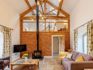a living room with a brick wall at 3 Bed in Whitchurch oc-88915 in Whixall