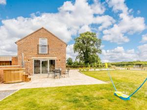 a brick house with a lawn and a mop at 3 Bed in Whitchurch oc-88915 in Whixall
