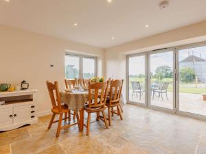 a kitchen and dining room with a table and chairs at 3 Bed in Whitchurch oc-88915 in Whixall