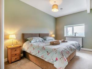a bedroom with a large bed and a window at 2 Bed in Llangammarch Wells oc-bn059 in Garth