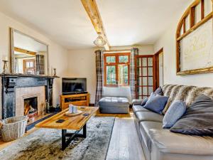 a living room with a couch and a fireplace at 4 Bed in Hereford oc-44213 in Hereford