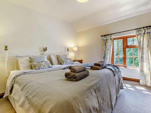a large bed in a bedroom with a large window at 4 Bed in Hereford oc-44213 in Hereford