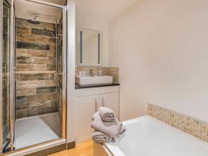a bathroom with a tub and a sink at 2 Bed in Newark oc-87683 in Coddington +11 photos