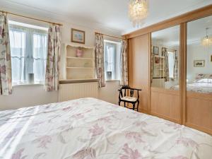 a bedroom with a large bed and a mirror at 1 Bed in Abergavenny oc-52882 in Gilwern