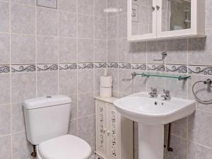 a bathroom with a toilet and a sink at 1 Bed in Abergavenny oc-52882 in Gilwern +19 photos
