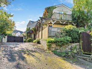 a house with a balcony and a driveway at 1 Bed in Abergavenny oc-52882 in Gilwern