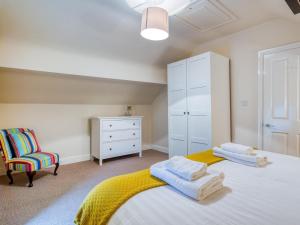 a bedroom with a bed and a dresser and a chair at 3 Bed in Buxton oc-77955 in Tideswell