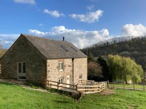 a sheep standing in front of a stone house at 2 Bed in Matlock oc-83435 in Bonsall