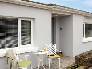 a patio with two chairs and a table at 1 Bed in Brixham oc-78520 in Galmpton-on-the-Dart