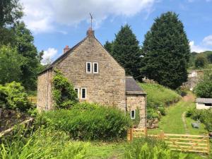 an old stone house on a hill with trees at 3 Bed in Belper oc-85797 in Crich