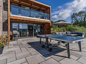 a ping pong table on a patio in front of a house at 4 Bed in Brecon oc-90596 in Bwlch