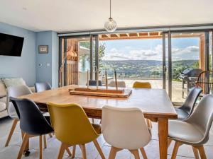 a dining room with a wooden table and chairs at 4 Bed in Brecon oc-90596 in Bwlch