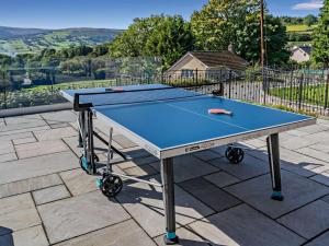 a blue ping pong table on a patio at 4 Bed in Brecon oc-90596 in Bwlch