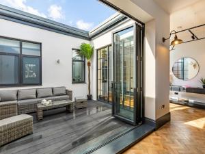 an open living room with a couch and windows at 5 Bed in Bideford oc-78690 in Bideford