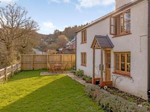 a white house with a yard with a fence at 2 Bed in Lydbrook oc-55961 in Lydbrook