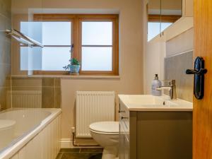 a bathroom with a toilet and a sink and a tub at 2 Bed in Lydbrook oc-55961 in Lydbrook