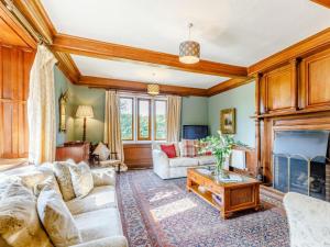 a living room with a couch and a fireplace at 8 Bed in Rugeley oc-79321 in Abbots Bromley