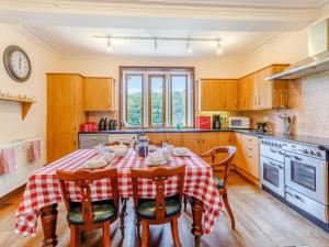 a kitchen with a table and four chairs and a kitchen with at 8 Bed in Rugeley oc-79321 in Abbots Bromley