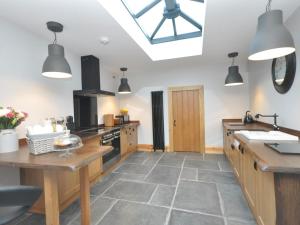 a large kitchen with wooden floors and a skylight at 2 Bed in Bath oc-47045 in Farmborough +12 photos