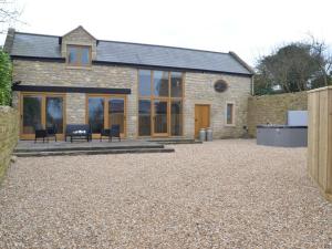 a stone house with glass doors and a patio at 2 Bed in Bath oc-47045 in Farmborough