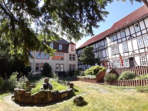 a building with a garden with a statue in front of it at Ursulinenkloster in Duderstadt