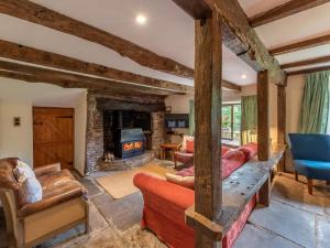 a living room with a stone fireplace and a couch at 4 Bed in Hereford oc-86497 in Llanveynoe