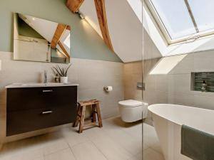 a bathroom with a skylight and a tub and a sink at 2 Bed in Hereford oc-82095 in Byford