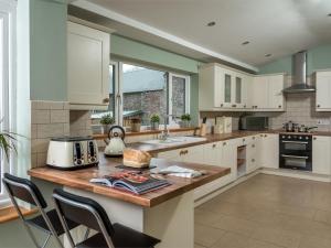 a kitchen with white cabinets and a counter with a toaster at 4 Bed in Brecon oc-bn151 in Devynock