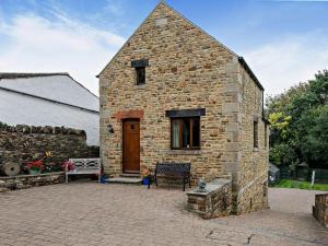 a brick building with a wooden door on a patio at 2 Bed in Dronfield oc-pk612 in Barlow