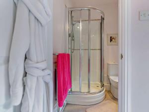 a bathroom with a shower with a pink towel at 2 Bed in Dronfield oc-pk612 in Barlow +7 photos