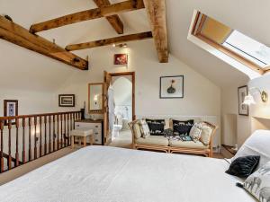 a bedroom with a large bed and a staircase at 2 Bed in Dronfield oc-pk612 in Barlow
