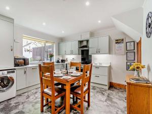 a kitchen with a table and chairs in a kitchen at 2 Bed in Ashbourne oc-85571 in Ashbourne +7 photos