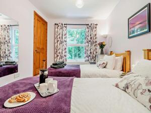 a bedroom with two beds and a table with a tray of food at 2 Bed in Ashbourne oc-85571 in Ashbourne
