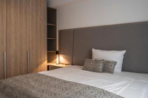 a bedroom with a large white bed with two pillows at Aparthotel Cosy in Stuttgart