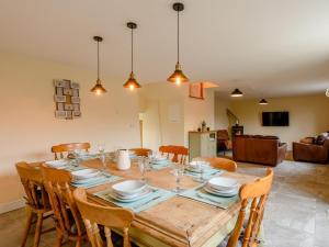 a dining room with a wooden table and chairs at 3 Bed in Matlock oc-78717 in Crich