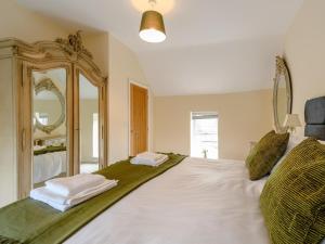 a bedroom with a large bed with a large mirror at 3 Bed in Matlock oc-78717 in Crich