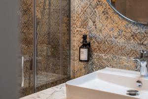 a bathroom with a sink and a shower at Aparthotel Cosy in Stuttgart +33 photos