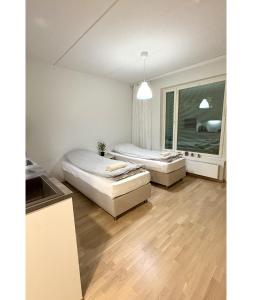a bedroom with two beds and a window at LuxHOMES Studio in Tapiola in Espoo