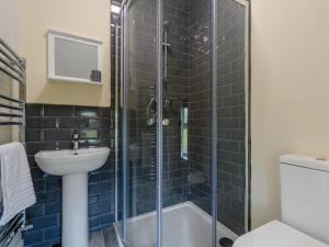 a bathroom with a shower and a sink and a toilet at 3 Bed in Matlock oc-78717 in Crich +25 photos
