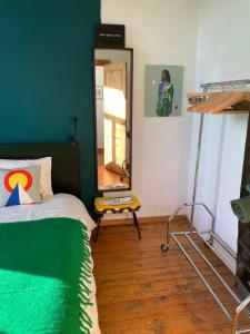 a bedroom with a bed and a mirror in it at Vintage Lovers Antwerp in Antwerp