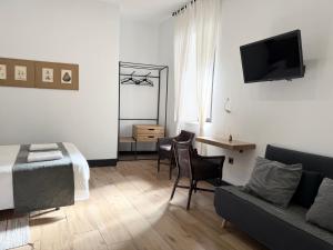a living room with a bed and a couch at Balhondo Open Village in Puebla de Alcocer
