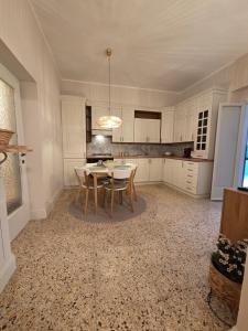 a kitchen with a table and chairs in a room at Casa Larissa in Rufina +14 photos