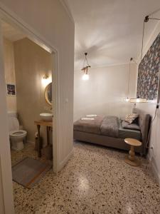 a bedroom with a bed and a sink and a toilet at Casa Larissa in Rufina