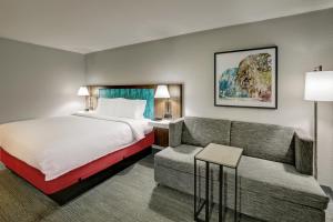 a hotel room with a bed and a couch at Hampton Inn Beaufort in Beaufort