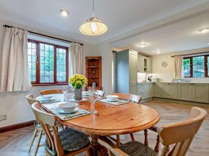a dining room with a wooden table and chairs at 5 Bed in Cheltenham oc-94643 in Lower Slaughter
