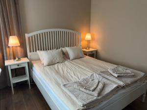 a bedroom with a bed with towels on it at SteneBo in Stenestad