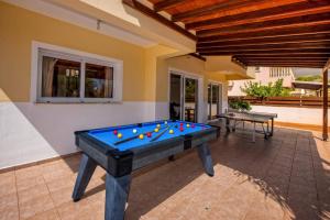 a pool table in the middle of a patio at Villa Semeli by Villa Plus in Peyia