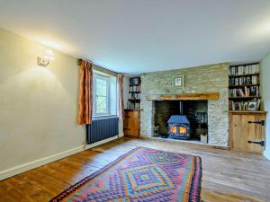 a living room with a fireplace and a stone wall at 6 Bed in Lechlade oc-93251 in Lechlade