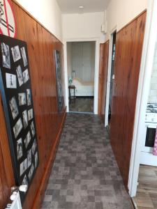 a hallway with wood paneling and a hallway with a room at L atelier du pain in Mesvres