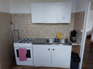 a kitchen with a white stove and a sink at L atelier du pain in Mesvres